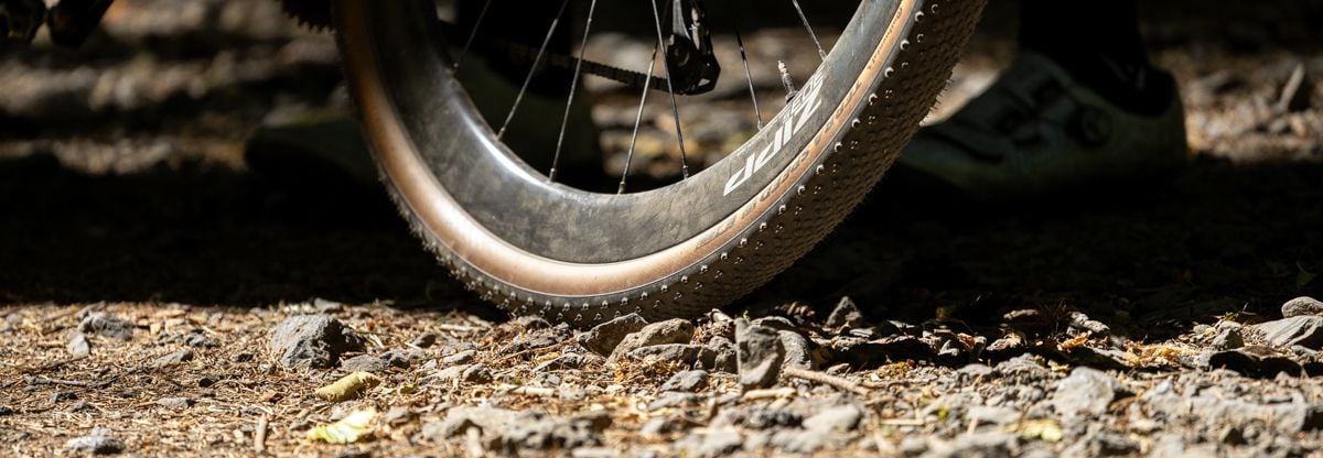 Bicycle wheel on gravel road.