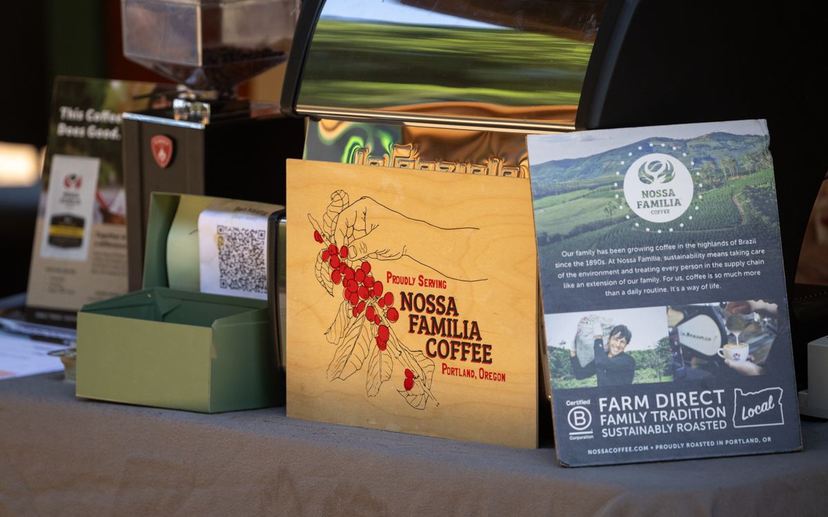 an espresso machine with nossa familia signage at a bike event