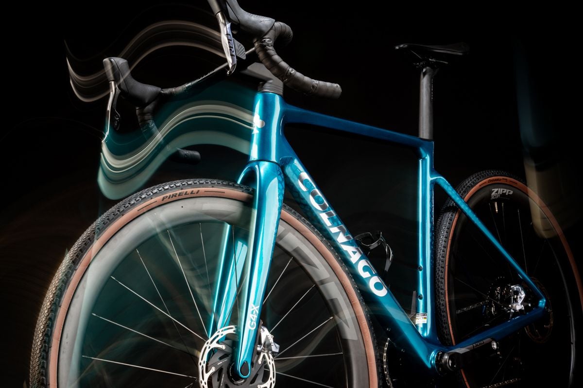 a blue colnago g4-x with motion blur effects on a black background