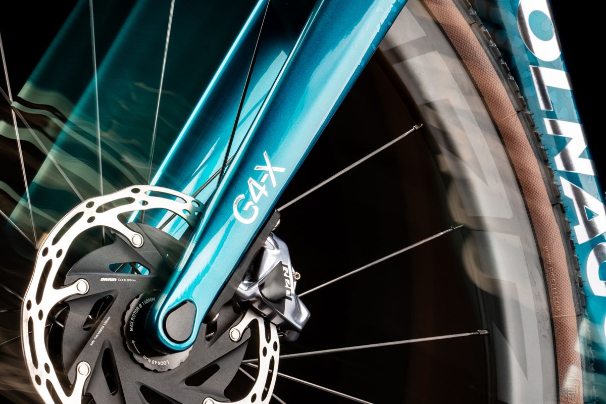 a detail of a blue colnago g4-x with motion blur effects on a black background