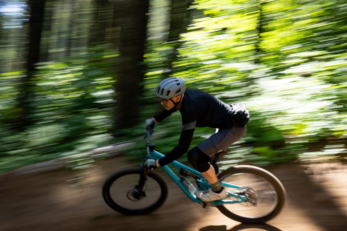 A mountain bike rider going around a turn with motion blur